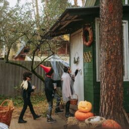 A group of kids trick-or-treating on Halloween.