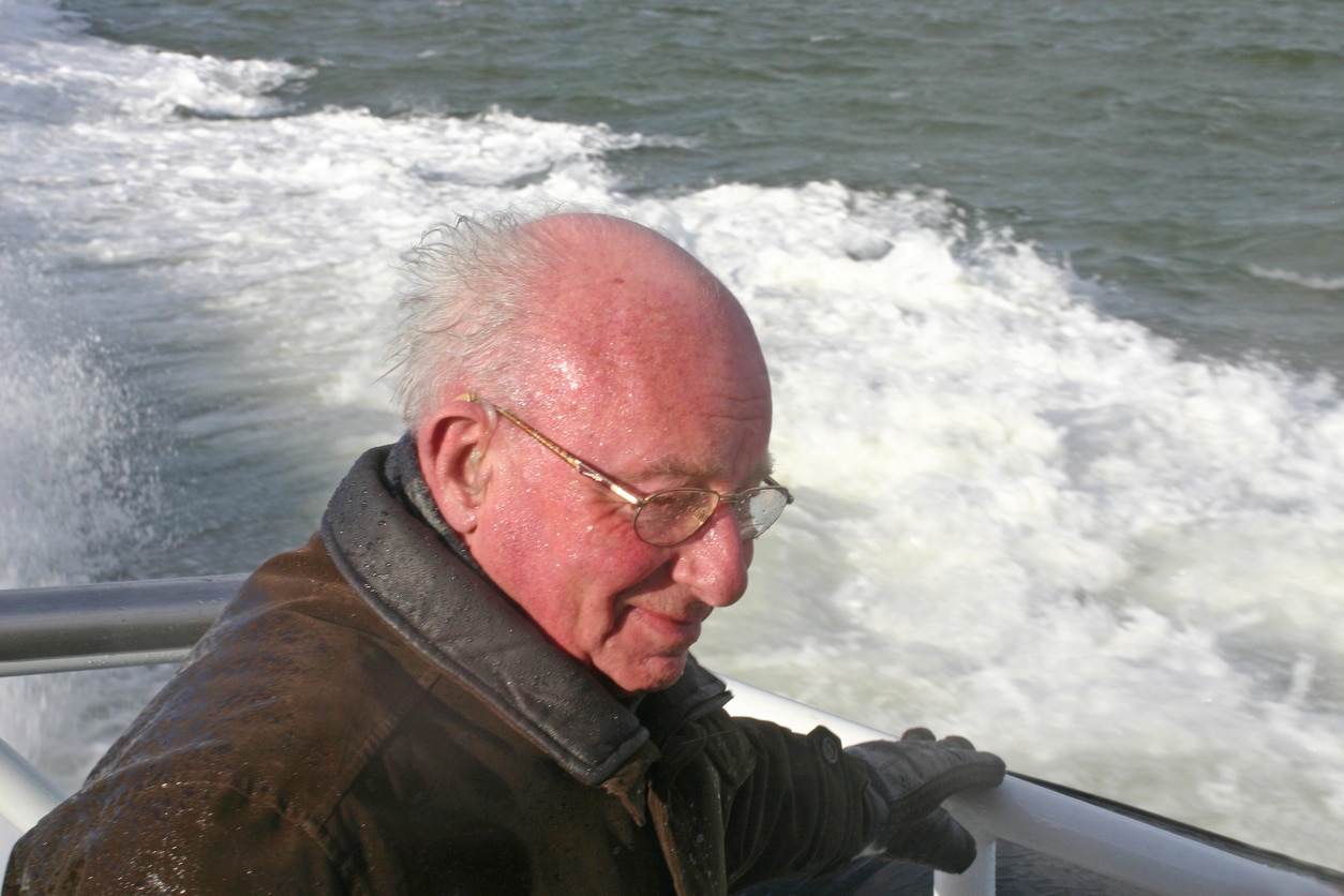 Mann on boat wearing a hearing aid.
