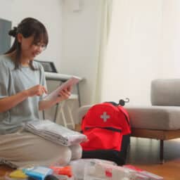 Woman preparing an emergency kit at home
